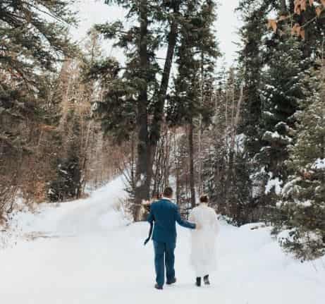 Kristina Werner with her husband, Derek Hansen on the middle of the snowy forest in California at the time of their wedding. What does Werner's husband do for a living?